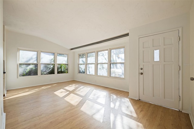 entryway featuring light hardwood / wood-style floors and lofted ceiling