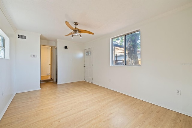 spare room featuring ceiling fan, light hardwood / wood-style flooring, and crown molding