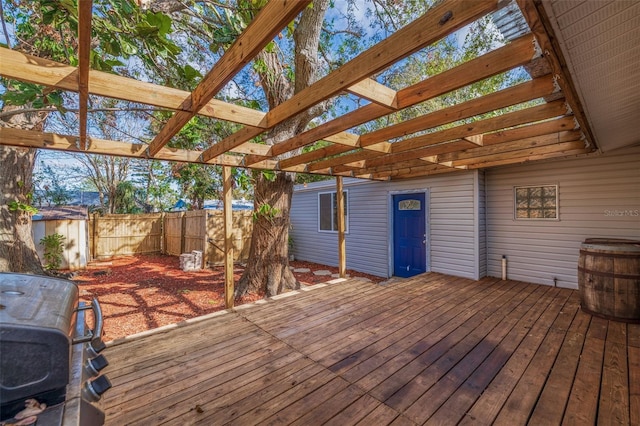 wooden terrace with a pergola and a shed