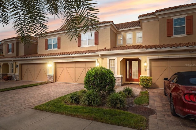 mediterranean / spanish home featuring a garage