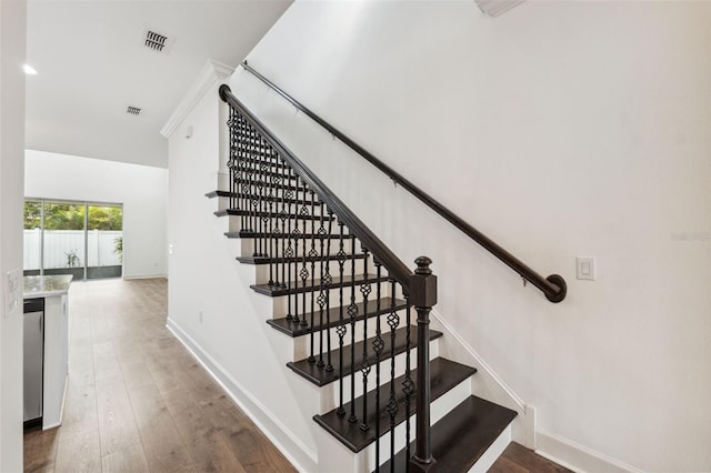 staircase featuring wood-type flooring