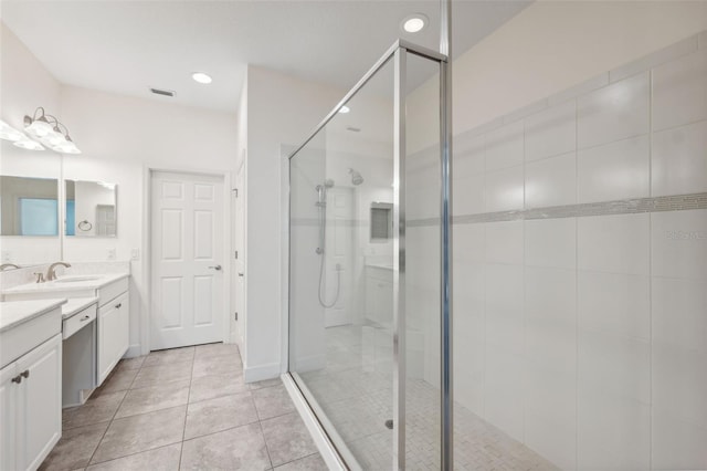 bathroom featuring tile patterned floors, vanity, and an enclosed shower