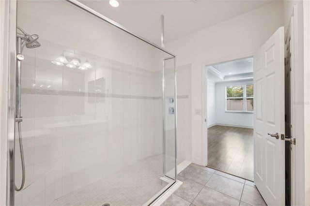 bathroom featuring hardwood / wood-style flooring and a shower with shower door