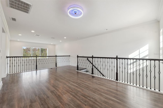 unfurnished room featuring dark hardwood / wood-style floors and ornamental molding