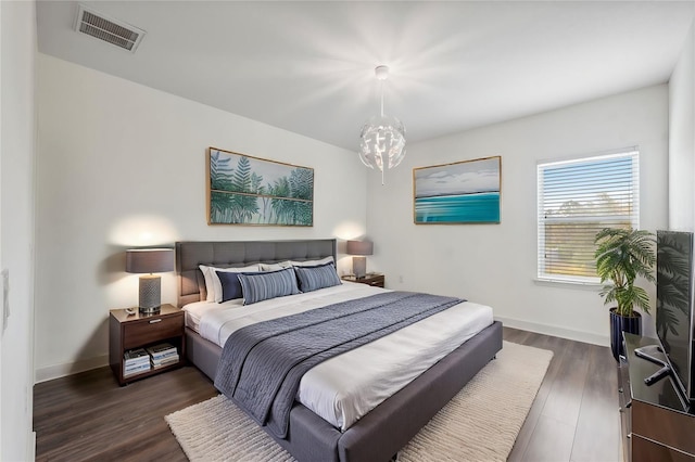 bedroom with dark wood-type flooring