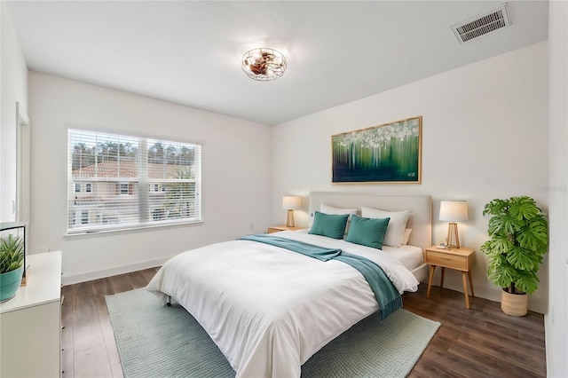 bedroom with dark hardwood / wood-style flooring