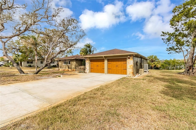 ranch-style home with a front yard, a garage, cooling unit, stone siding, and driveway