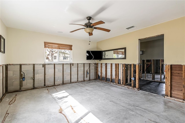 empty room featuring ceiling fan and visible vents