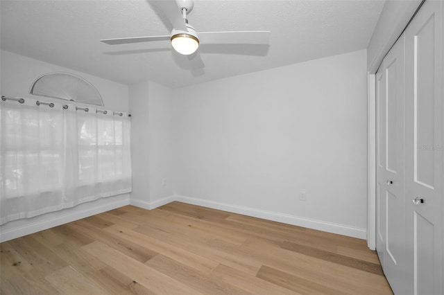 interior space featuring a textured ceiling, light hardwood / wood-style flooring, and ceiling fan