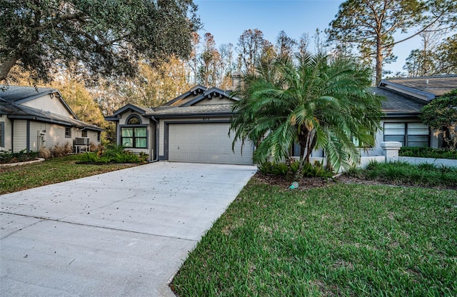 view of front of house with a garage and a front yard