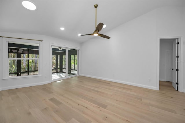 unfurnished living room featuring a wealth of natural light, ceiling fan, light hardwood / wood-style floors, and vaulted ceiling