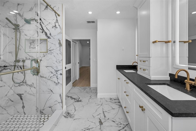 bathroom with vanity and a shower with shower door