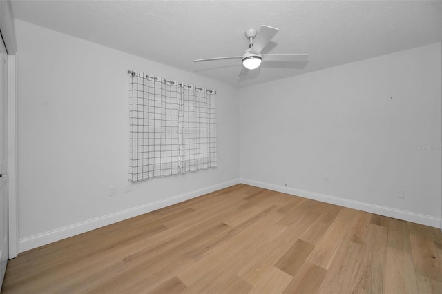 unfurnished room featuring a textured ceiling, light hardwood / wood-style flooring, and ceiling fan