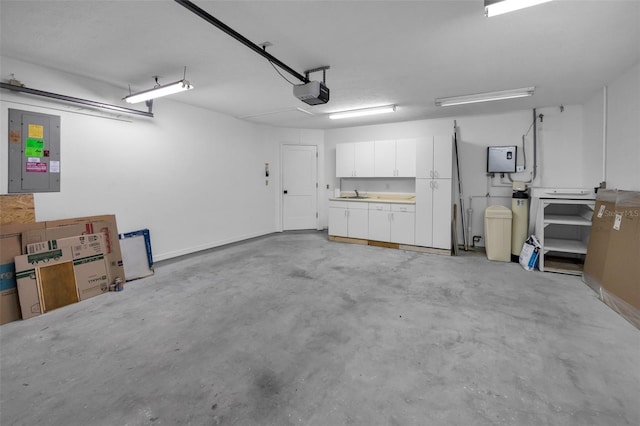 garage with a garage door opener and electric panel