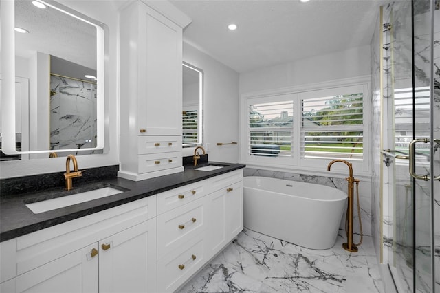 bathroom featuring vanity, a textured ceiling, and independent shower and bath