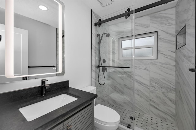 bathroom with vanity, toilet, an enclosed shower, and a textured ceiling