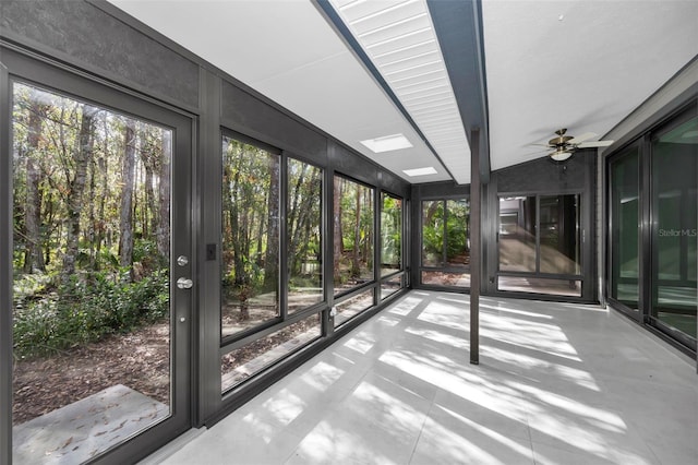 unfurnished sunroom with vaulted ceiling and ceiling fan