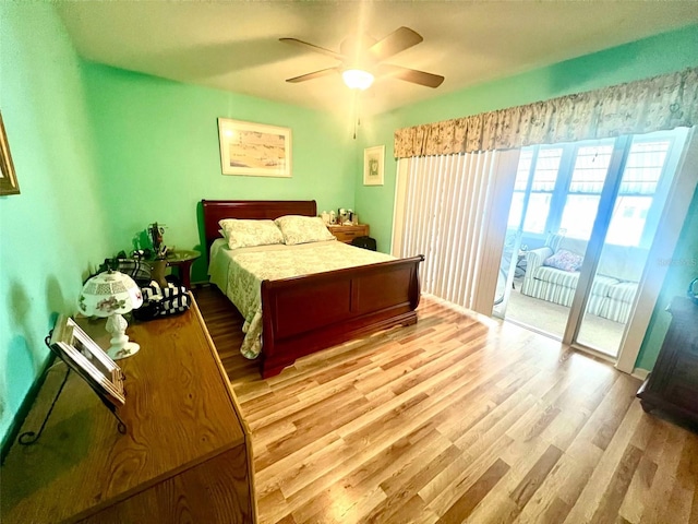 bedroom featuring access to outside, light wood-type flooring, and ceiling fan