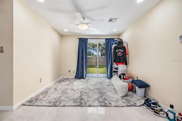 interior space with access to exterior and ceiling fan