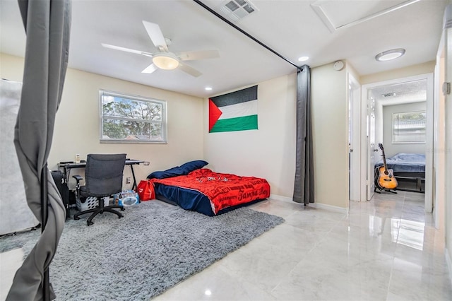 bedroom with multiple windows and ceiling fan