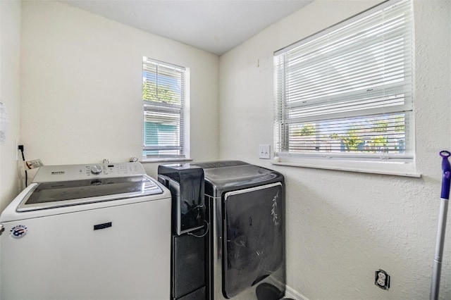 clothes washing area featuring independent washer and dryer