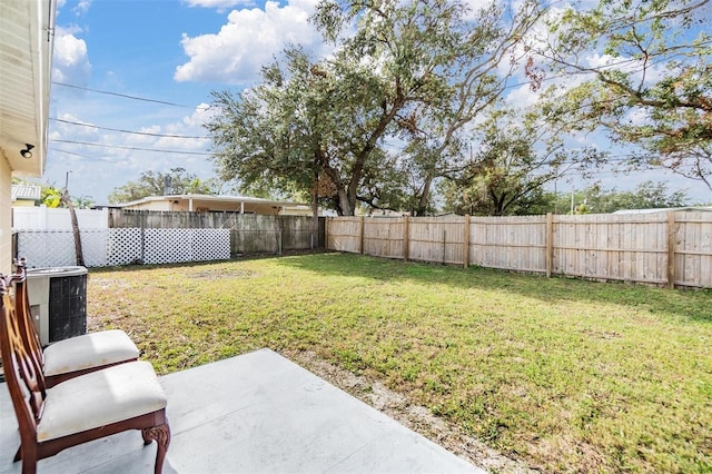 view of yard featuring a patio and central AC