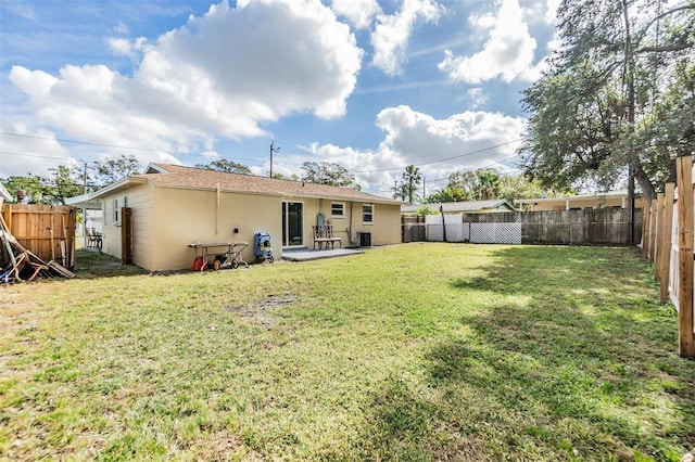 rear view of house with a yard