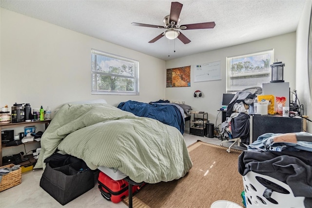 carpeted bedroom featuring multiple windows, ceiling fan, and a textured ceiling