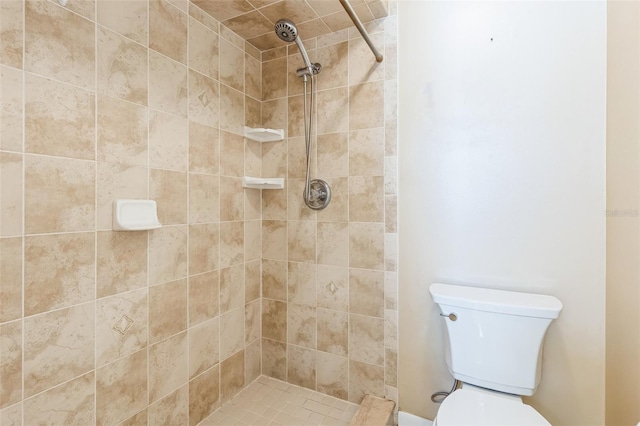 bathroom with tiled shower and toilet