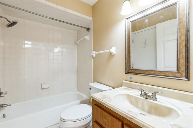 full bathroom with tiled shower / bath, vanity, and toilet