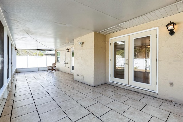 unfurnished sunroom featuring french doors