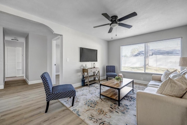 living room with ceiling fan and light hardwood / wood-style floors