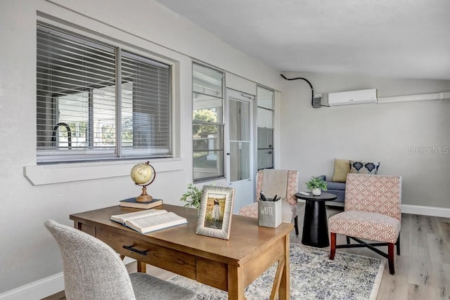 office with lofted ceiling, plenty of natural light, wood-type flooring, and a wall mounted air conditioner