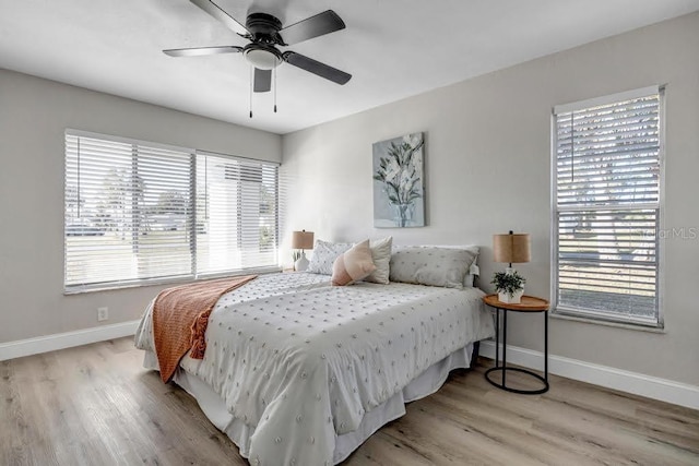 bedroom with light hardwood / wood-style flooring and ceiling fan