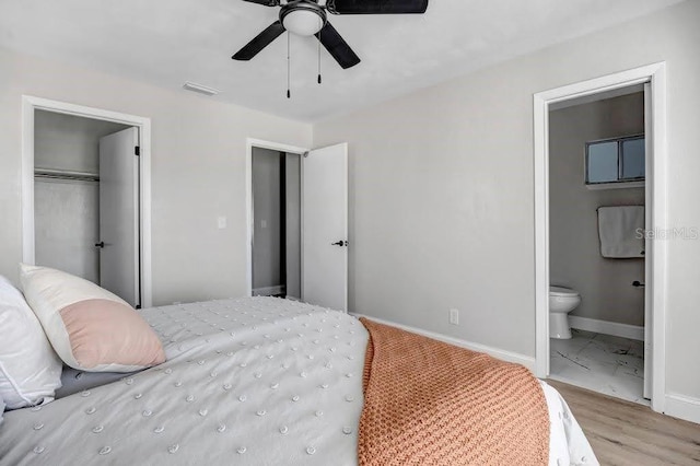 bedroom featuring a closet, connected bathroom, ceiling fan, and light hardwood / wood-style flooring