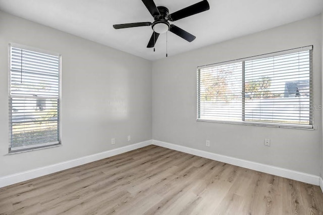 unfurnished room with ceiling fan, a healthy amount of sunlight, and light wood-type flooring