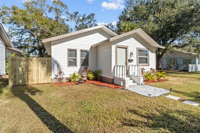 bungalow-style house featuring a front yard and fence