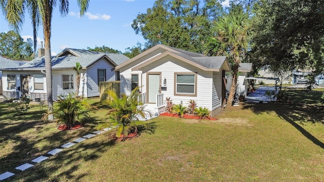 bungalow-style home with a front yard