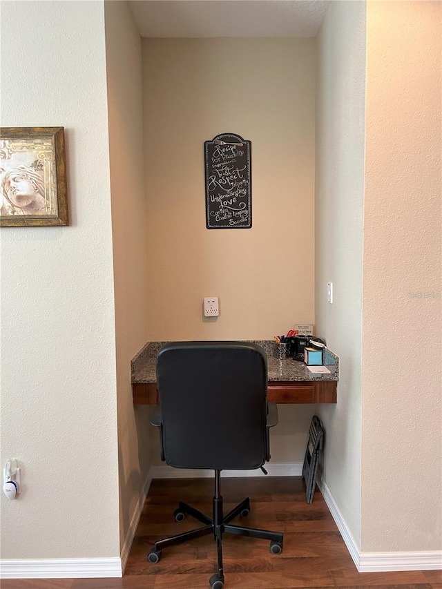 office space featuring built in desk and wood-type flooring