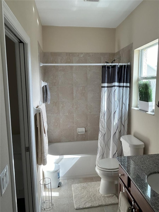 full bathroom featuring toilet, vanity, tile patterned floors, and shower / bath combination with curtain