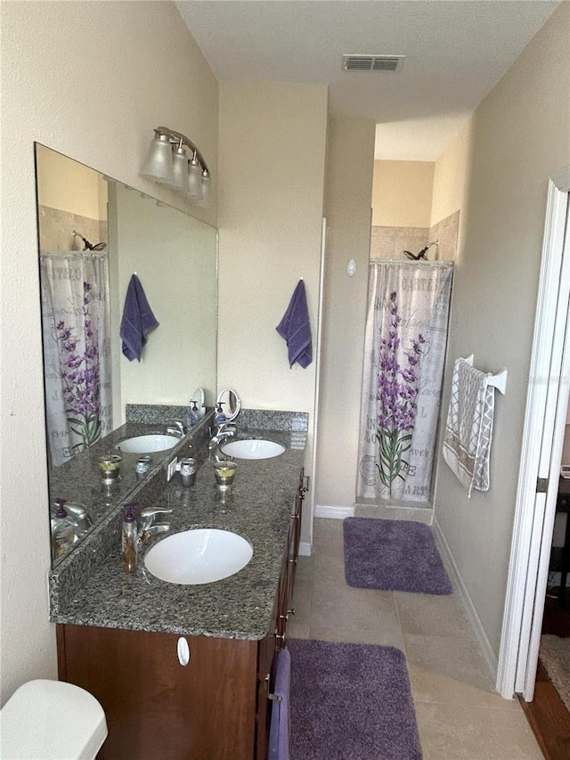 bathroom featuring tile patterned floors, vanity, and a shower with curtain