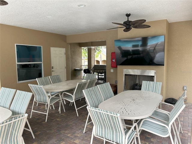 dining area featuring a textured ceiling and ceiling fan