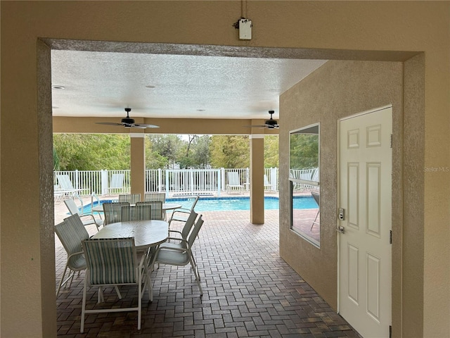 view of pool with ceiling fan and a patio area