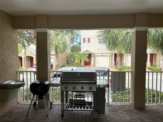 view of patio featuring a grill and a garage