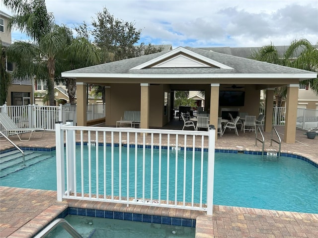 view of swimming pool featuring ceiling fan, a patio area, and a gazebo