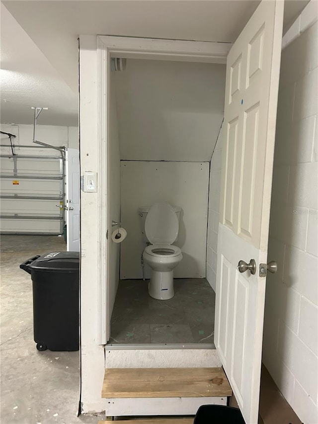 bathroom featuring toilet and concrete floors