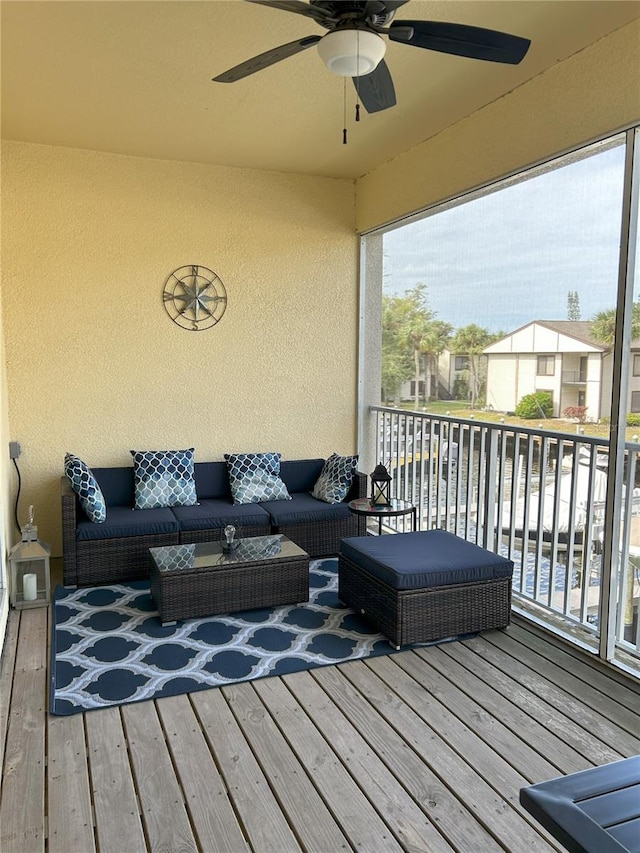 deck with ceiling fan and an outdoor living space