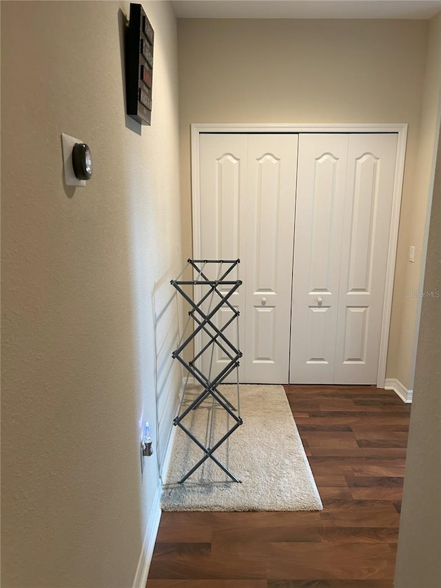 corridor with dark hardwood / wood-style floors