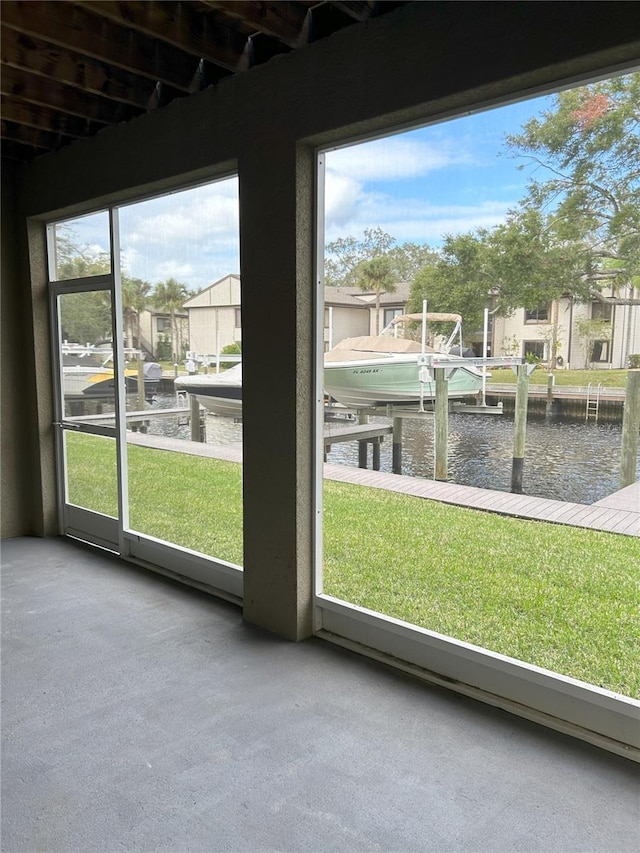 unfurnished sunroom featuring a water view and a wealth of natural light