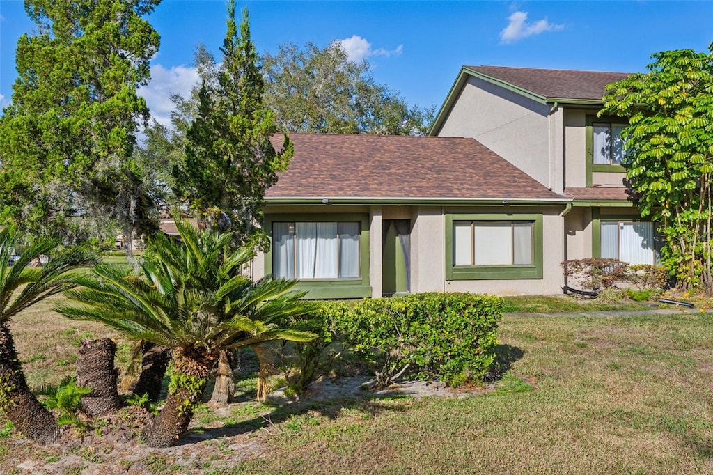 rear view of property with a lawn